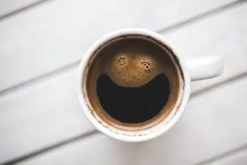 Cup of coffee from a clean coffee maker with a smiley face